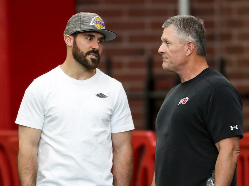 University of Utah head football coach Kyle Whittingham talks with former University of Utah All-American Eric Weddle.
