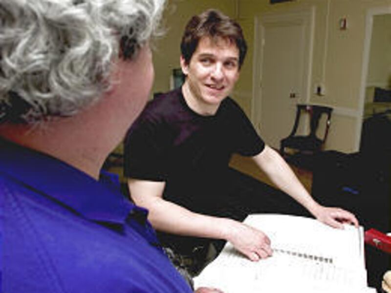 Keith Lockhart, right, the conductor of the Boston Pops, talks with Dennis Alves, the artistic director, following a rehearsal.