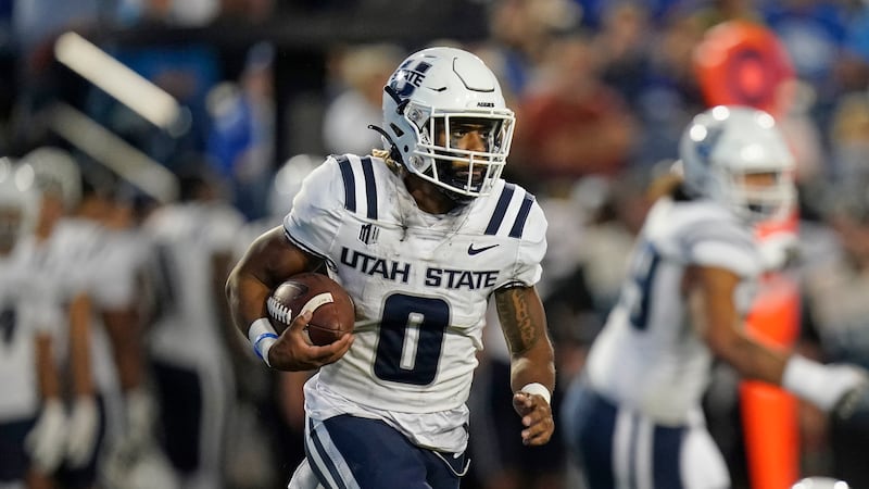 Utah State receiver Terrell Vaughn carries the ball against BYU during game on Sept. 29, 2022, in Provo, Utah.