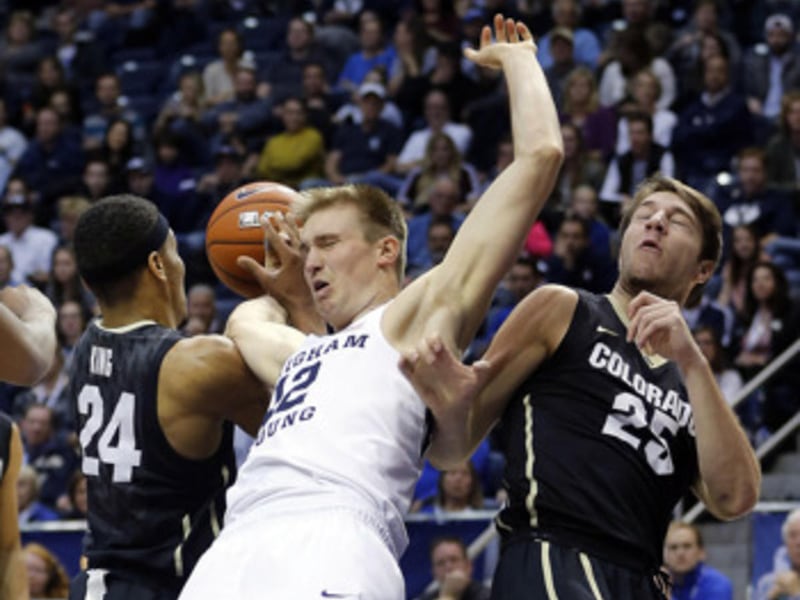 Brigham Young Cougars forward Eric Mika (12) fights for a rebound with Colorado Buffaloes guard George King (24) and forward Lucas Siewert (25) during NCAA basketball in Provo on Saturday, Dec. 10, 2016.