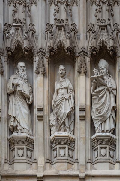 Sculptures of Pater Kolbe, left, Manche Masemola and Janani Jakaliya Luwum at the western gate of Westminster Abbey, in the row of the 20th-century martyrs, shown in London on Oct. 3, 2013.