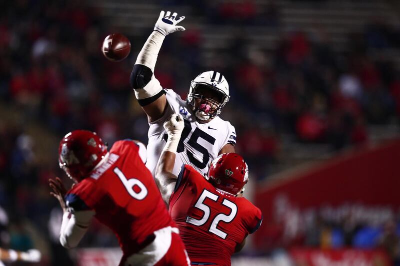 BYU defensive tackle Khyiris Tonga tries to bat down a pass during the game against Fresno State in Fresno, California, Saturday, Nov. 4, 2017. Tonga is optimistic the D-line will be better in 2020.