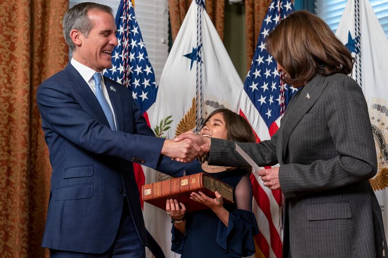 Eric Garcetti, left, next to his daughter Maya Garcetti, is sworn in as ambassador to India by Vice President Kamala Harris, Friday, March 24, 2023.