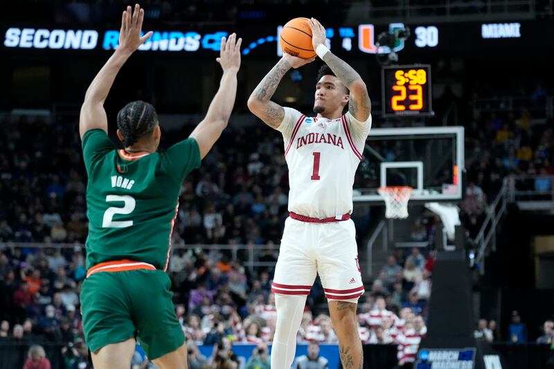 Indiana’s Jalen Hood-Schifino (wearing white) shoots
