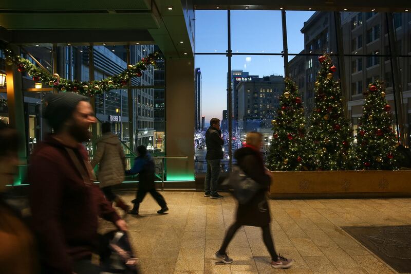 People walk through the City Creek sky bridge over Main Street in downtown Salt Lake City on Wednesday, Dec. 7, 2016.
