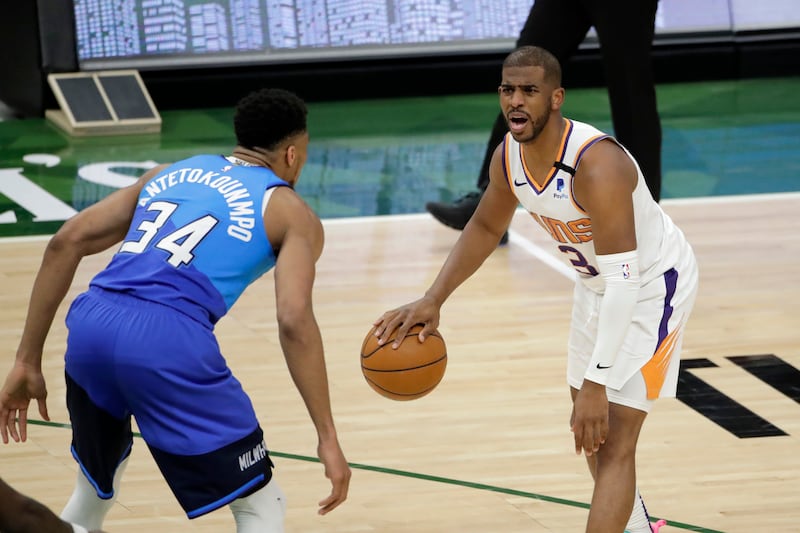 Phoenix Suns’ Chris Paul dribbles against Milwaukee Bucks’ Giannis Antetokounmpo during the second half of an NBA game.
