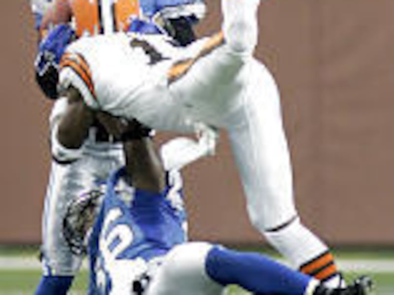 Cleveland receiver Braylon Edwards is upended as Keith Smith intercepts the pass.