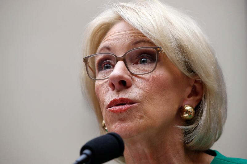 In this May 22, 2018, file photo, Education Secretary Betsy DeVos testifies at a House Committee on Education and the Workforce, on Capitol Hill in Washington. The Trump administration is rescinding Obama-era guidance that encouraged schools to take a per