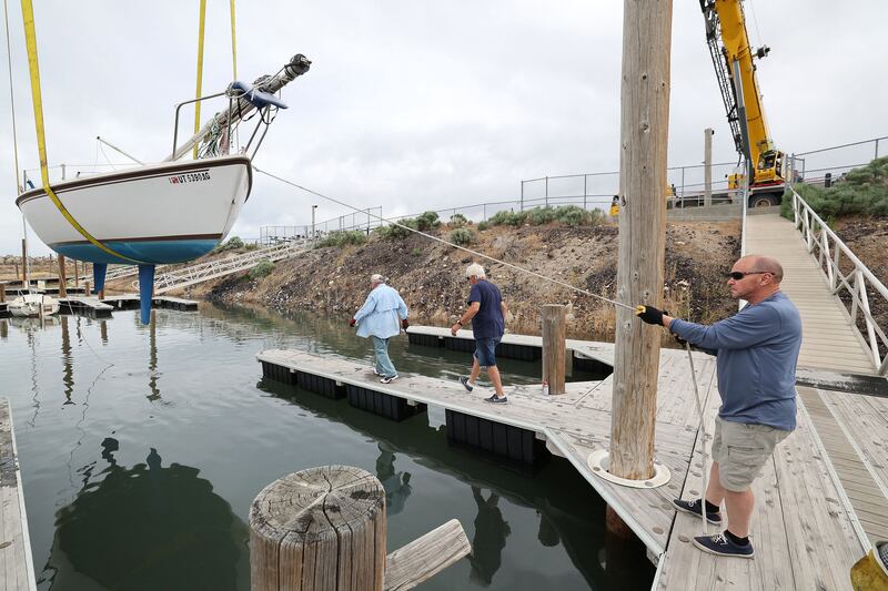 Sailboats are hoisted back into the Great Salt Lake marina in Salt Lake City on Tuesday. Water levels have raised enough for sailing on the lake.
