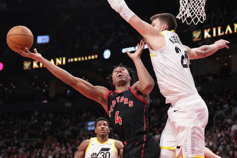 Toronto Raptors forward Scottie Barnes (4) shoots against Utah Jazz centerWalker Kessler (24) during second-half NBA basketball game action in Toronto, Saturday, Dec. 23, 2023. (Chris Young/The Canadian Press via AP)
