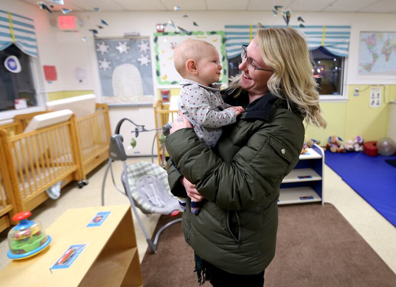Kelsey Hixson-Bowles picks up her daughter River Hixson-Gray from La Petite Academy of Sandy in Sandy on Friday, Jan. 19, 2018.
