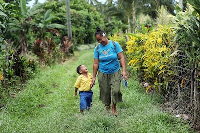 Fa'amele Fa'atuai makes the hour long walk home with her son Lupi following activities at Foundational Learning preschool at the Siumu Ward in Siumu, Samoa, on Thursday, May 16, 2019.