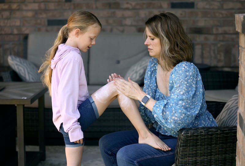 MaryAnn Gerber puts sunscreen on her daughter Maggie Gerber, 8, at their home in Layton on Tuesday, June 27, 2023.