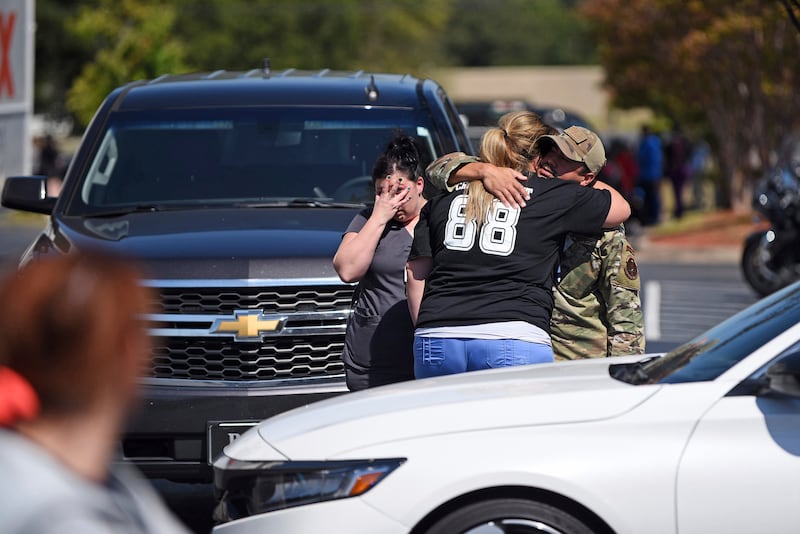 People console one another as local law enforcement respond to an active shooter at the CHI St. Vincent North in Sherwood, Ark.