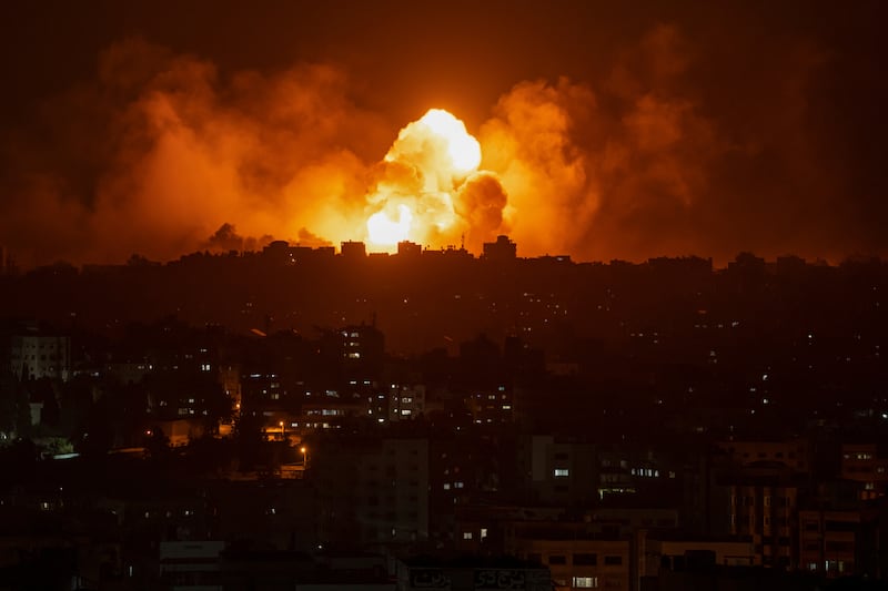 Fire and smoke rise following an Israeli airstrike, in Gaza City, Sunday, Oct. 8, 2023.