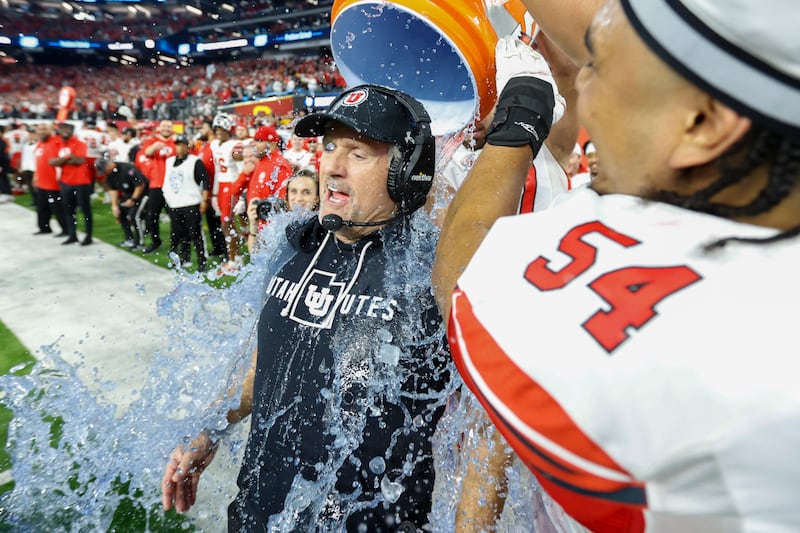 Utah Utes head coach Kyle Whittingham is doused in celebration before beating the USC Trojans in the Pac-12 Championship.
