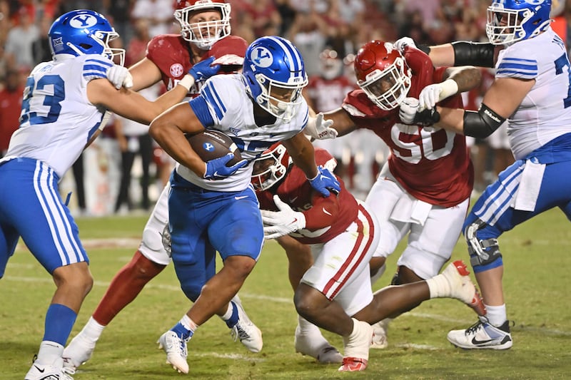 BYU running back LJ Martin (27) runs for a gain against Arkansas during the second half of an NCAA college football game Saturday, Sept. 16, 2023, in Fayetteville, Ark.