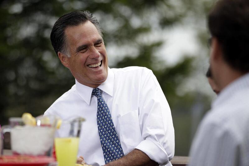 In this April 17, 2012 file photo, Republican presidential candidate, former Massachusetts Gov. Mitt Romney shares a laugh while meeting with a group of Pittsburgh area residents in Bethel Park, Pa,