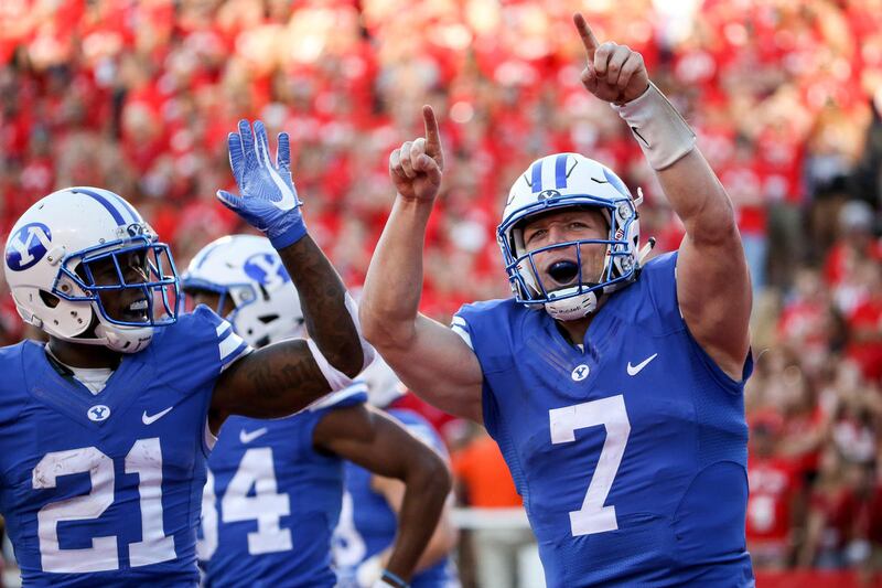 Brigham Young Cougars quarterback Taysom Hill (7) celebrates after running the ball in for a touchdown, putting BYU up 13-7 after the PAT, during a game against Utah at Rice-Eccles Stadium in Salt Lake City on Saturday, Sept. 10, 2016.