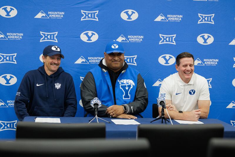 BYU coach Kalani Sitake, center, is flanked by offensive coordinator Aaron Roderick, left, and defensive coordinator Jay Hill