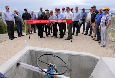 Hunt Willoughby, chairman of the North Utah County Water Conservancy District, cuts a ribbon for the Battle Creek and Grove Creek dams at the Battle Creek Dam and Debris Basin in Pleasant Grove on Monday, June 17, 2019.