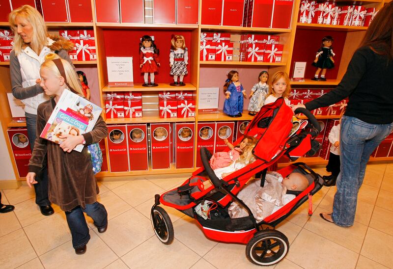 Customers shop for dolls at the American Girl Place store at The Grove shopping mall in Los Angeles.
