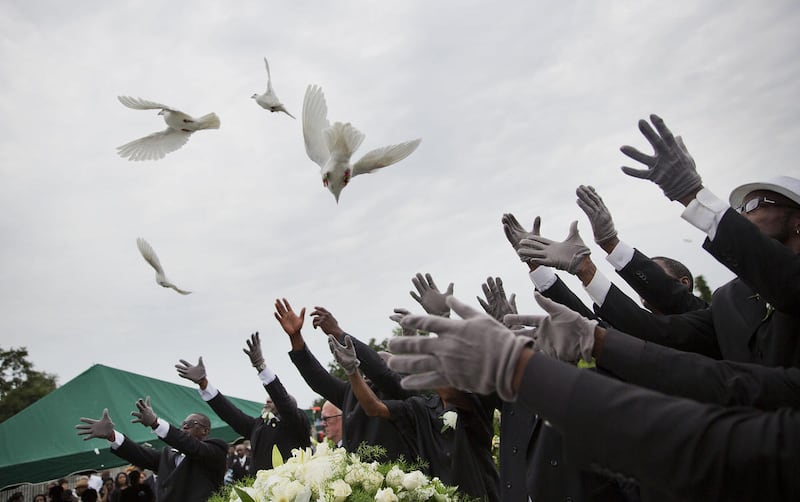 Pallbearers release doves over the casket of Ethel Lance during her burial service, Thursday, June 25, 2015, in Charleston, S.C. Lance was one of the nine people killed in the shooting at Emanuel AME Church in Charleston last week. (AP Photo/David Goldman