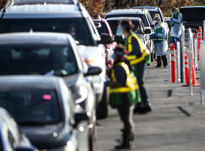 Salt Lake County mobile testers gather information from people as they wait in long lines to get tested for COVID-19 at the county’s testing site in the Maverik Center parking lot in West Valley City on Tuesday, Nov. 17, 2020.
