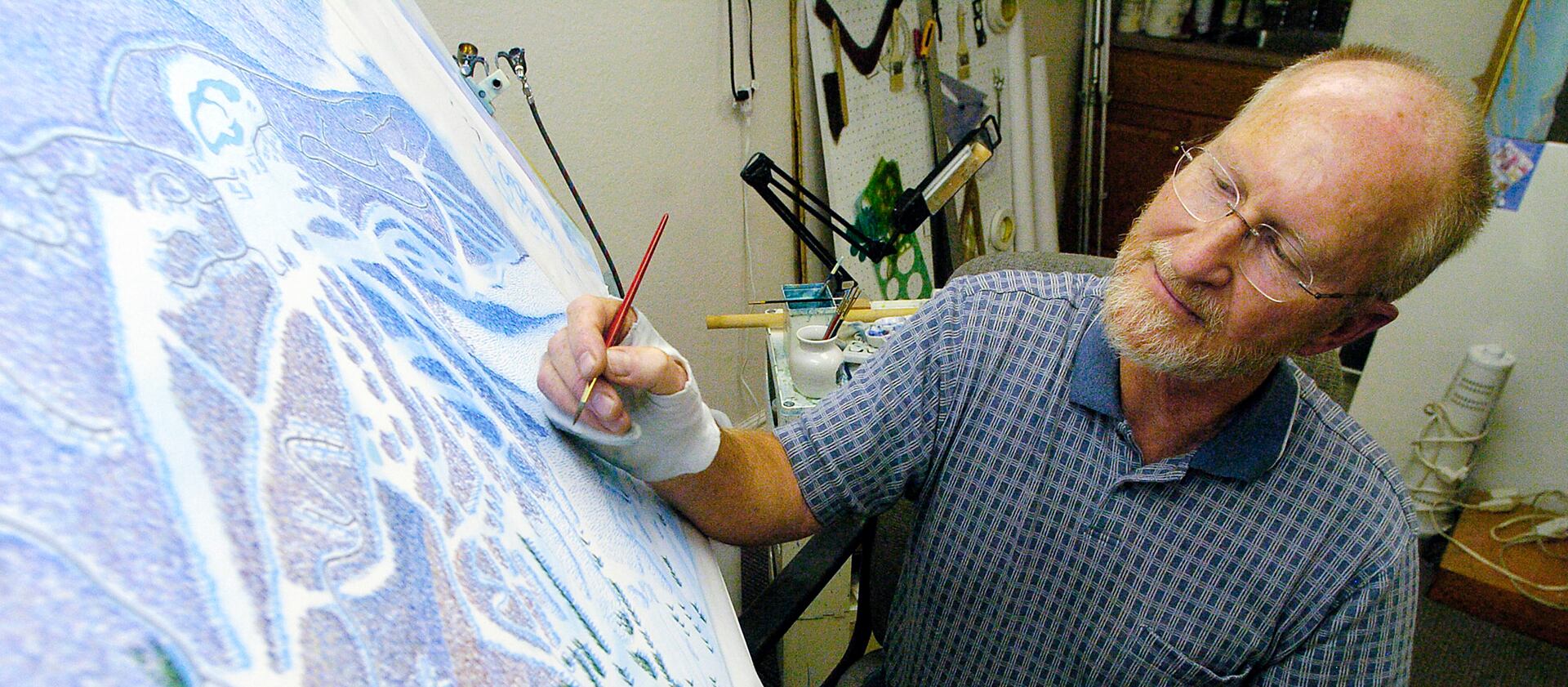 James Niehues paints a ski map.