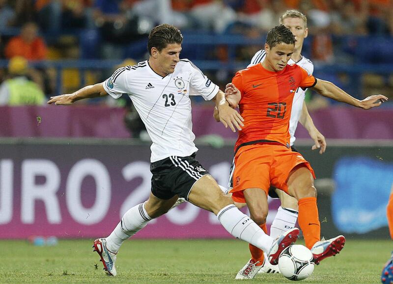 Germany's Mario Gomez, left, and Ibrahim Afellay from the Netherlands fight for the ball during the Euro 2012 soccer championship Group B match between the Netherlands and Germany in Kharkiv, Ukraine, Wednesday, June 13, 2012.