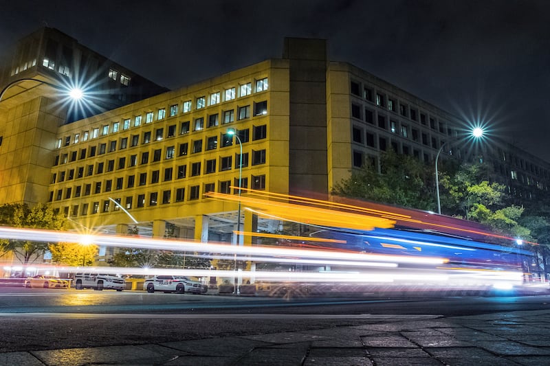Traffic along Pennsylvania Avenue in Washington streaks past the Federal Bureau of Investigation headquarters building on Nov. 1, 2017.