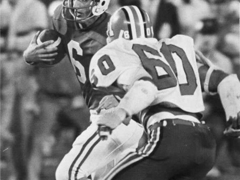 BYU Quarterbacks online photo gallery. 
BYU's Marc Wilson scrambles for yards as Indiana linebacker Craig Walls zeros in.
Search words: Brigham Young University