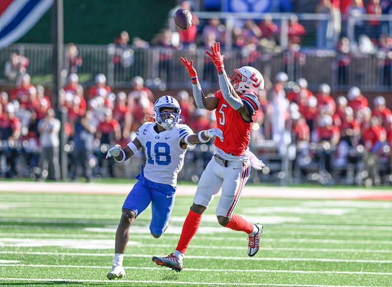 Liberty wide receiver Noah Frith, catches a pass as BYU’s Kaleb Hayes defends during an NCAA college football game, Saturday, Oct. 22, 2022, in Lynchburg, Va.