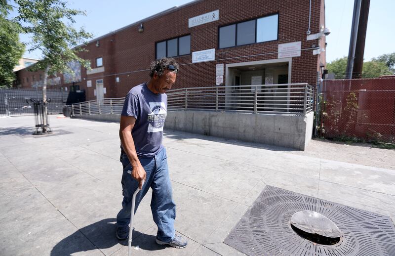 A man walks by the Road Home in Salt Lake City on Wednesday, Aug. 8, 2018.