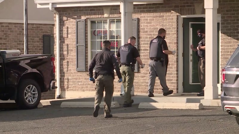 Police officers in at Small Rainbow where people were arrested after an investigation into massage parlors.