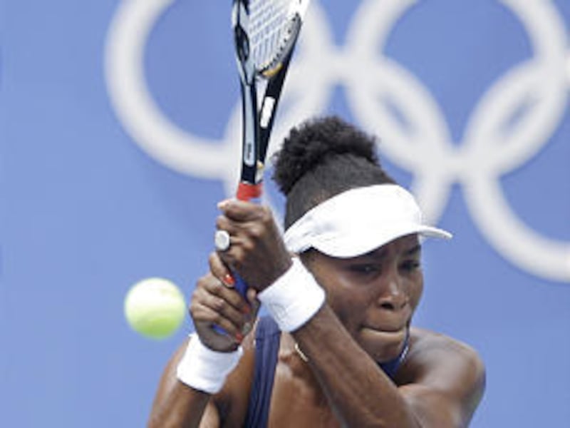 Venus Williams, of the United States, returns a shot against Iveta Benesova, of the Czech Repubic, during the first round of the women's singles tennis of the Beijing 2008 Olympics.