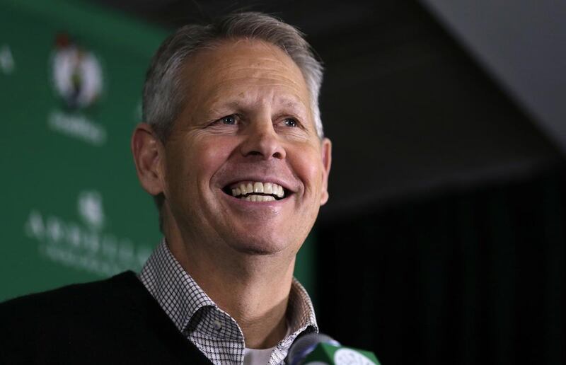 Danny Ainge, Boston Celtics president of basketball operations, smiles as he discusses the trade of point guard Rajon Rondo prior to an NBA basketball game in Boston, Friday, Dec. 19, 2014. Ainge's commitment to his faith and family is featured in a Feb.