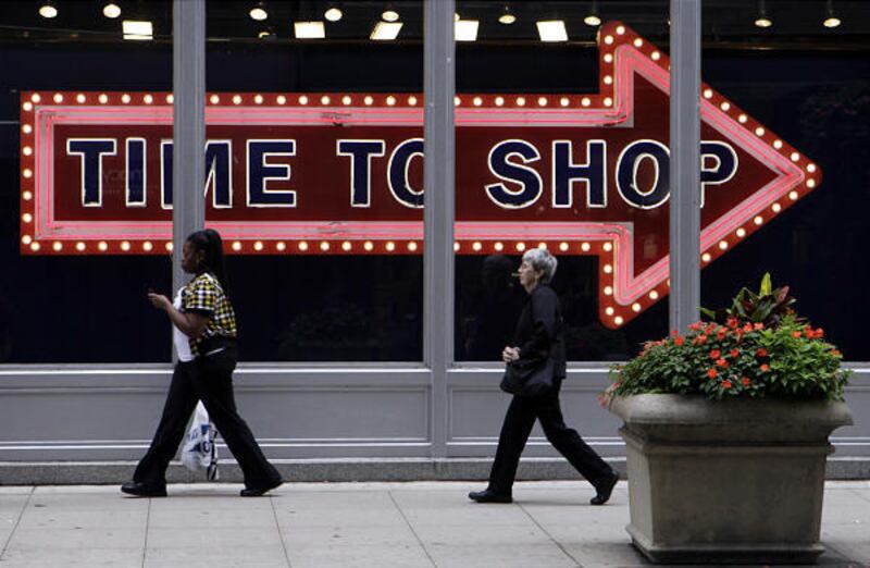 In this Sept. 21, 2009 photo, pedestrians walk by the window display at an Old Navy store in Monday, Sept. 21, 2009, in downtown Chicago. Consumers' confidence in the economy falls in September as Americans' worries about job security offset any enthusias