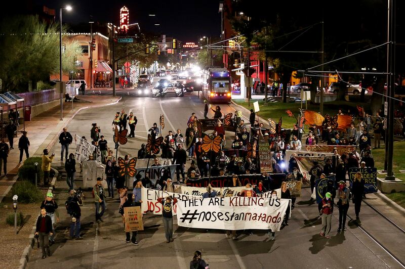 Protesters march through downtown in response to a jury finding U.S. Border Patrol agent Lonnie Swartz not guilty of involuntary manslaughter in the cross-border shooting death of Mexican teen Jose Antonio Elena Rodriguez, Wednesday, Nov. 21, 2018, in Tuc