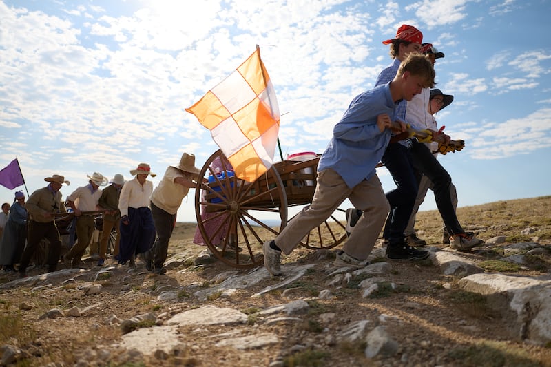 Youth from the Hooper Utah Pioneer Trail Stake pull handcarts along the Wyoming Mormon Trail near Lander, Wyoming, as they relive a mid-1800s pioneer experience known today as “trek” by members of The Church of Jesus Christ of Latter-day Saints, July 7-9, 2025.