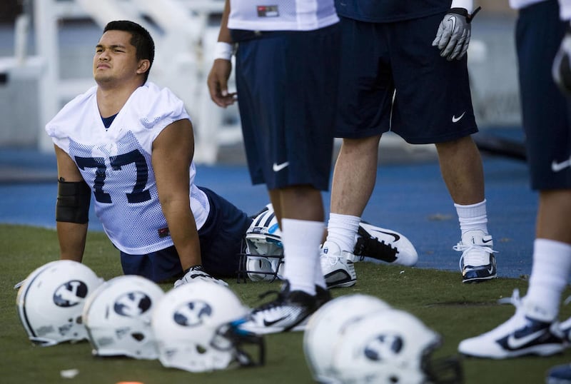 Ian Dulan stretches out at the BYU Football Practice Field in Provo on Saturday, Aug. 6, 2011.