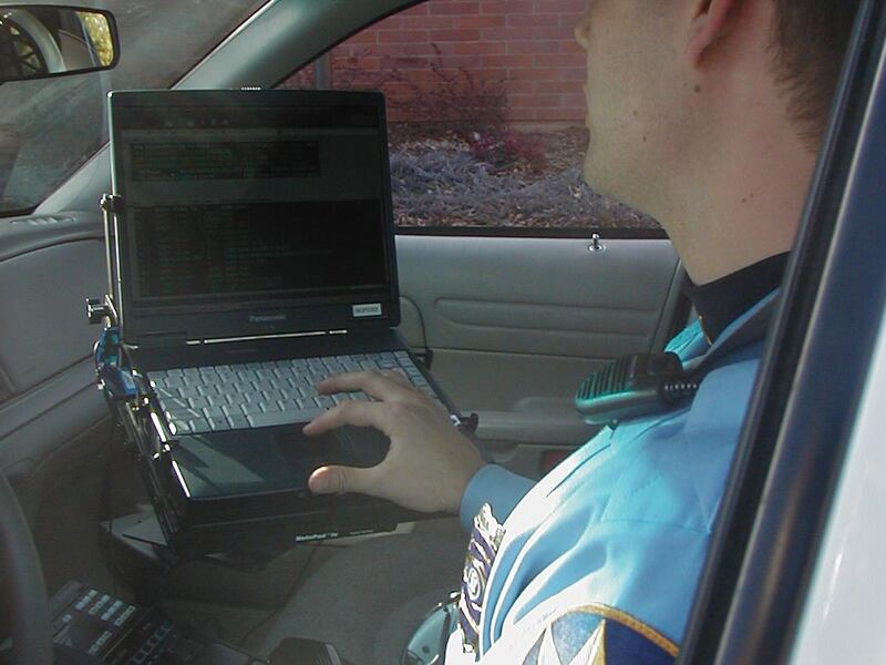 St. George Police Officer Jeff Bahlmann uses a new laptop computer and wireless mobile dispatch system installed in his patrol car. Photo by Nancy Perkins