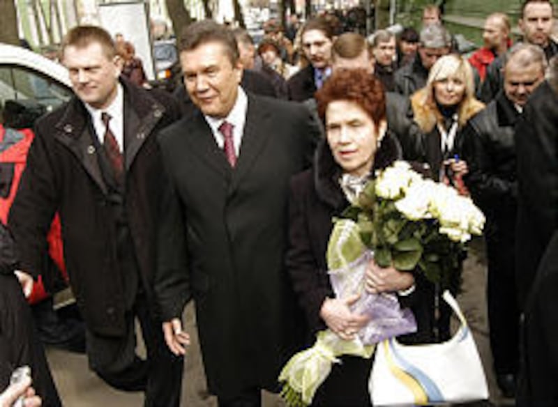 Pro-Moscow opposition leader Viktor Yanukovych and his wife, Lyudmila, leave a polling station in Kiev, Ukraine.