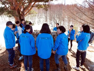 The River of Life School students assemble around a shrine that marks the meeting point of Korea’s three main watersheds.