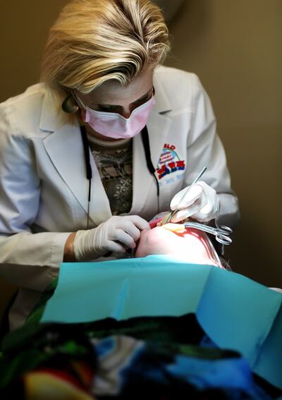 Dr. Jennifer Brown works on Mersadie Clark's teeth at Hillfield Pediatric & Family Dentistry in Layton on Tuesday, Nov. 28, 2017.