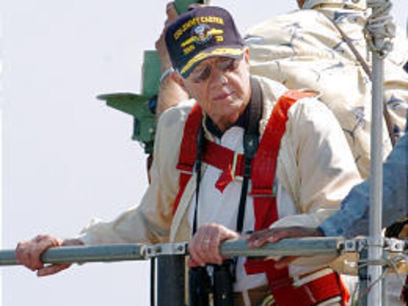 Former President Jimmy Carter leans on the railing of submarine USS Jimmy Carter as it docks in Georgia Friday.