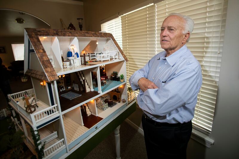 Larry Elkins shows a dollhouse he built matching the dream home he and his late wife Linda had planned to build as he talks about their life together and their family on Wednesday, March 27, 2019.