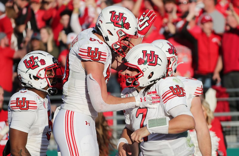 Utah Utes quarterback Cameron Rising celebrates his touchdown with Utah Utes tight end Brant Kuithe during the Rose Bowl.