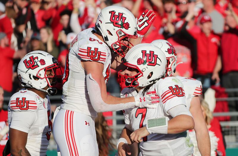 Utah Utes quarterback Cameron Rising celebrates his touchdown with Utah Utes tight end Brant Kuithe during the Rose Bowl.