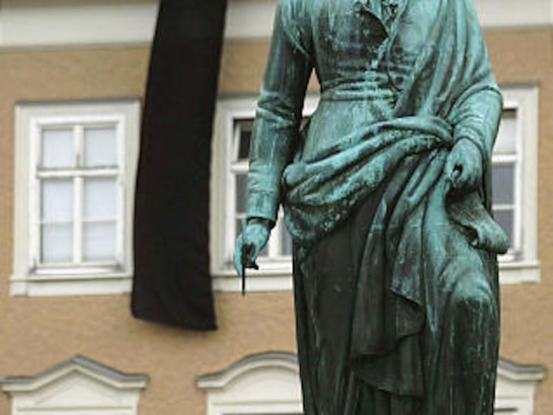 This is a Nov. 2000 file photo of a statue of Austrian composer Wolfgang Amadeus Mozart stands in front of a house in Salzburg Austria.